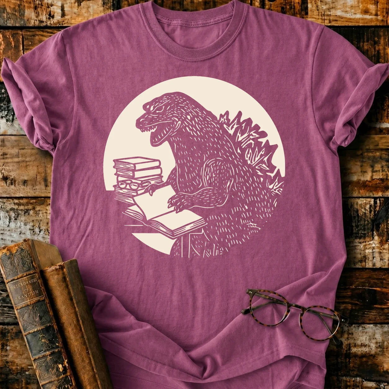 Readzilla T-shirt: Garment-dyed maroon cotton tee with a white graphic of Godzilla reading books.