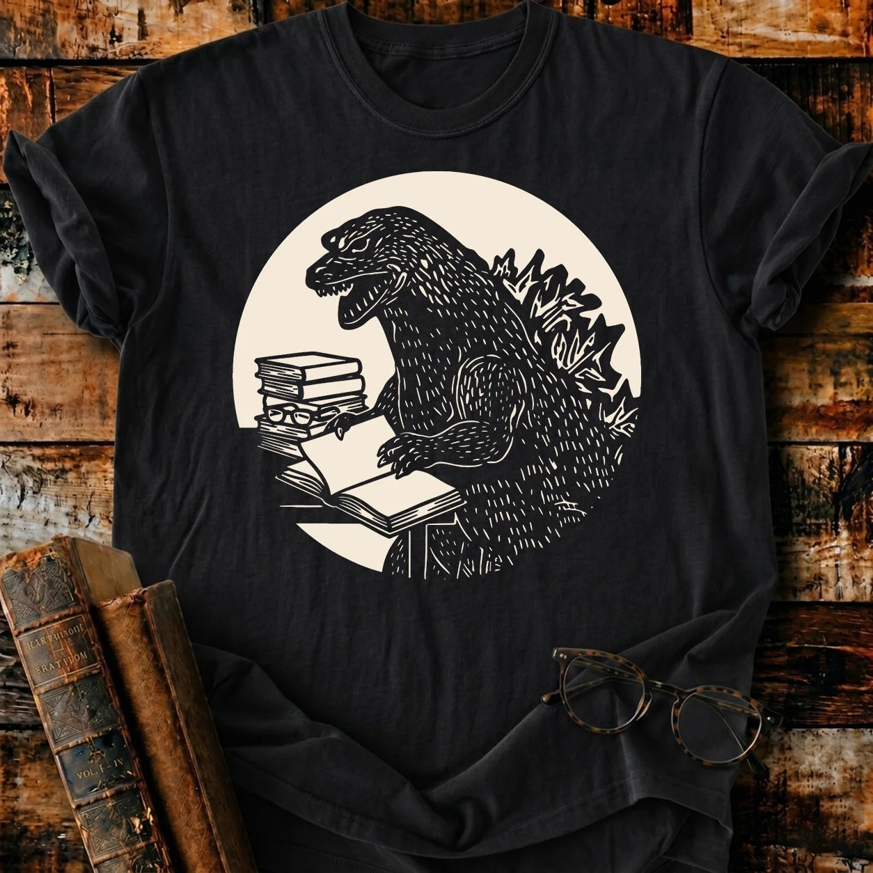 Black Comfort Colors Readzilla T-shirt with Godzilla reading books, relaxed fit, 100% US cotton.