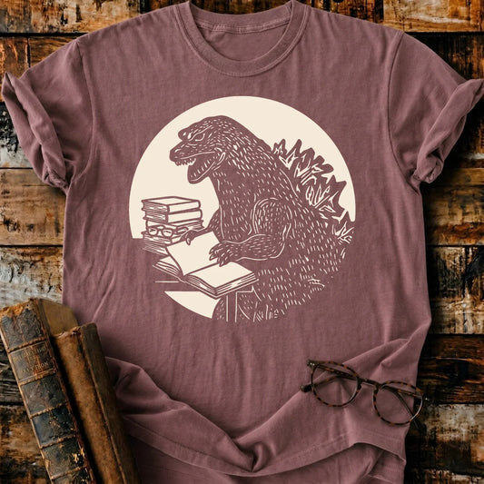 Readzilla T-shirt: Garment-dyed brown Comfort Colors tee with a Godzilla reading books graphic.