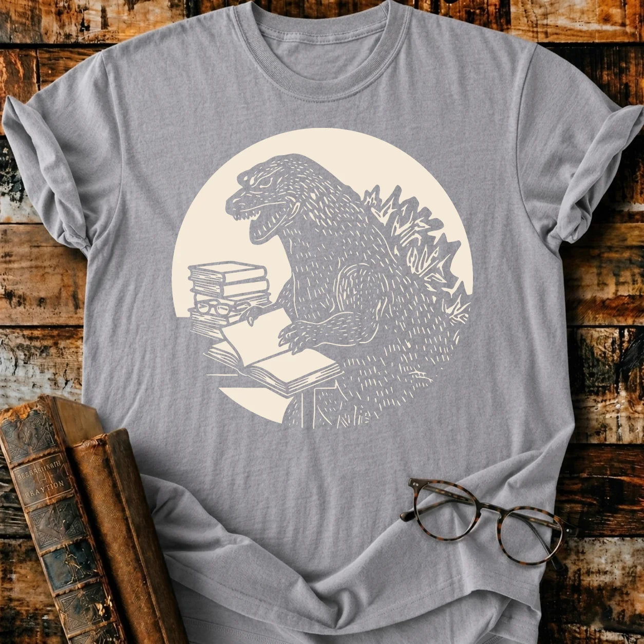 Gray Comfort Colors Readzilla T-shirt with Godzilla reading books, relaxed fit, 100% US cotton.