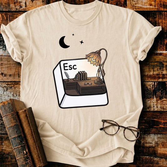 Comfort Colors Escape T-shirt, natural color, with a desk scene inside an "Esc" key, books, and moon design.