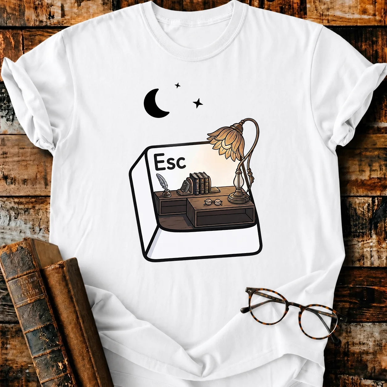 White Comfort Colors Escape T-shirt with a desk, books, lamp, and moon design.